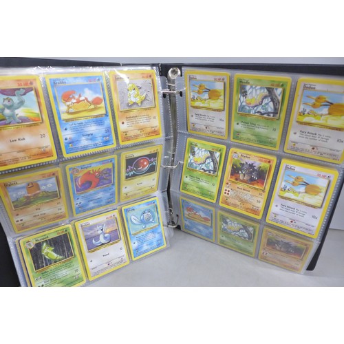 A vintage wizards of the coast Pokemon card binder, containing 300 cards  including 4th print, holofo