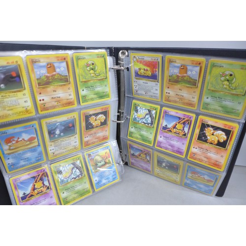 A vintage wizards of the coast Pokemon card binder, containing 300 cards  including 4th print, holofo