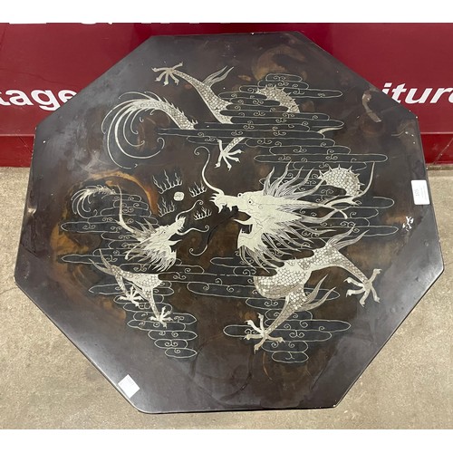 45 - A Chinese black lacquered Chinoiserie octagonal two tier occasional table