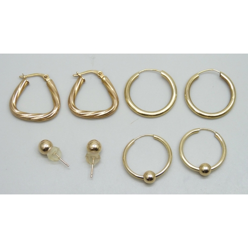 7030 - A pair of 9ct gold earrings, two pairs of yellow metal hoop earrings and a pair of yellow metal stud... 