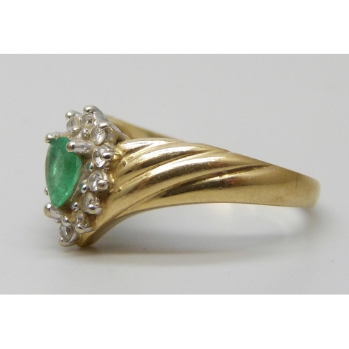7035 - A 14k gold, emerald and diamond cluster ring, 3.4g, M