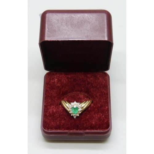 7035 - A 14k gold, emerald and diamond cluster ring, 3.4g, M