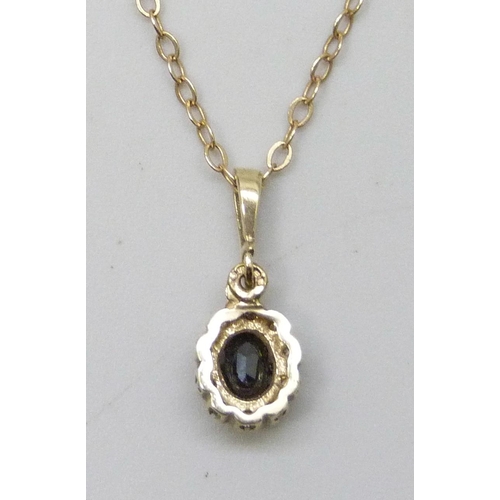 7039 - A 9ct gold, sapphire and diamond cluster pendant on a 9ct gold necklace chain (repair to clasp), 1.9... 