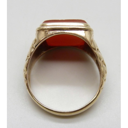 7040 - A 9ct gold ring set with a carnelian intaglio seal depicting a knight on horseback, 12.7g, X