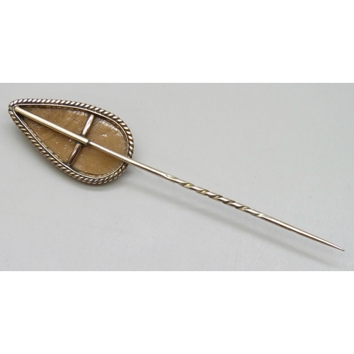 7051 - A yellow metal framed cameo stick pin, 5g, 8.3cm