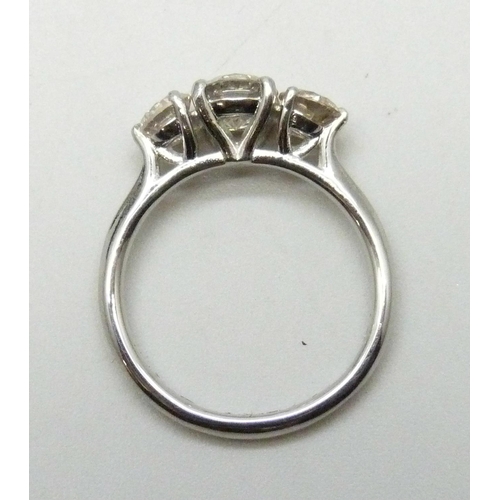 7117 - A platinum set three stone diamond ring, total diamond weight 1.50ct, (centre diamond 0.78cts), 4.2g... 