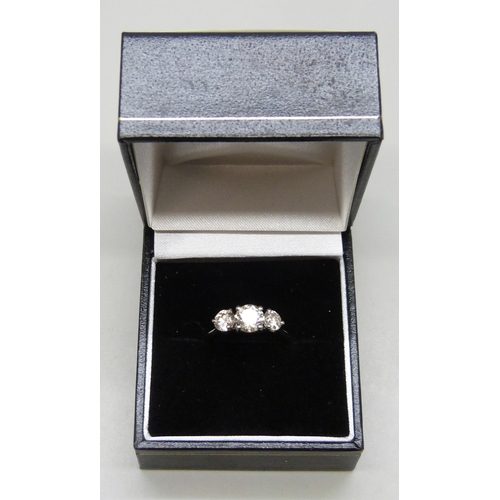 7117 - A platinum set three stone diamond ring, total diamond weight 1.50ct, (centre diamond 0.78cts), 4.2g... 