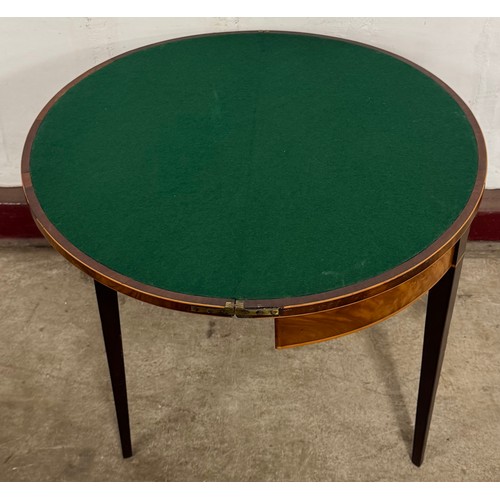 79 - A George III inlaid mahogany demi-lune fold over card table