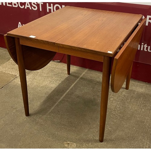 38A - A teak drop-leaf extending dining table, attributed to Arne Vodder