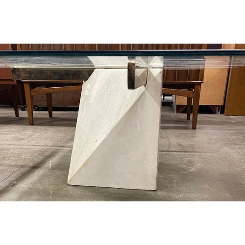 82A - An Italian style travertine stone and glass topped coffee table