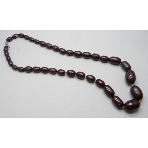 A plastic bead necklace, and a Bakelite box