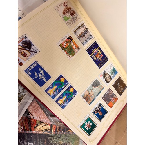 2111 - A box of stamp albums, covers, etc.