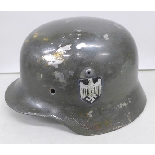 2038 - A German World War II helmet shell, M35, with later added post war decal detail