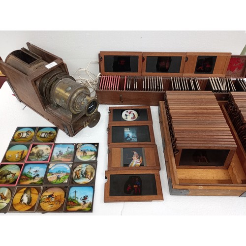 2199 - A large 19th Century wooden and brass magic lantern with three boxes of slides including humour, map...