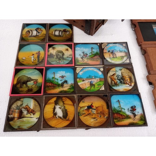 2199 - A large 19th Century wooden and brass magic lantern with three boxes of slides including humour, map... 