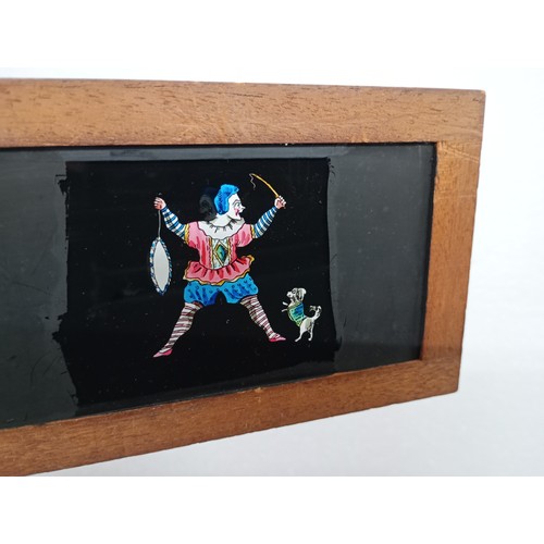 2199 - A large 19th Century wooden and brass magic lantern with three boxes of slides including humour, map... 