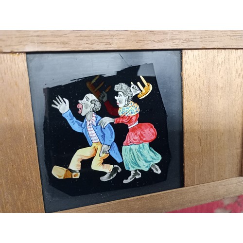 2199 - A large 19th Century wooden and brass magic lantern with three boxes of slides including humour, map... 