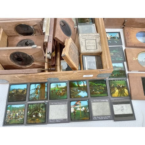 2199 - A large 19th Century wooden and brass magic lantern with three boxes of slides including humour, map... 