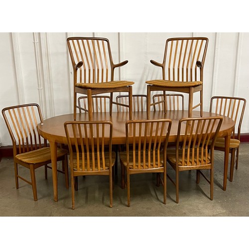 48 - A Danish Faarup M&oslash;belfabrik teak circular extending dining table, designed by Ib Kofod Larsen and a ...