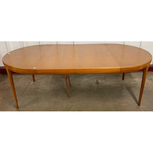 48 - A Danish Faarup Møbelfabrik teak circular extending dining table, designed by Ib Kofod Larsen and a ... 