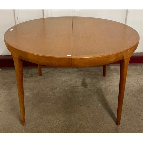 48 - A Danish Faarup Møbelfabrik teak circular extending dining table, designed by Ib Kofod Larsen and a ... 