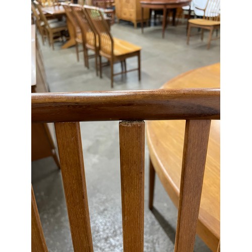 48 - A Danish Faarup Møbelfabrik teak circular extending dining table, designed by Ib Kofod Larsen and a ... 