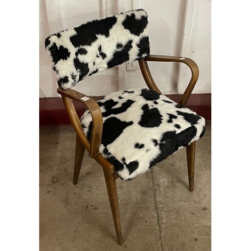 76 - A beech and cow print upholstered elbow chair