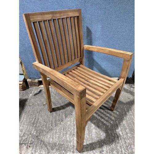 3075 - A teak circular folding garden table and a pair of teak carver chairs