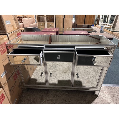 3115 - A mirrored three drawer three door sideboard (crack on doors)