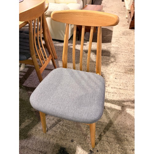 3086 - An oak oval dining table with six oak and grey fabric dining chairs