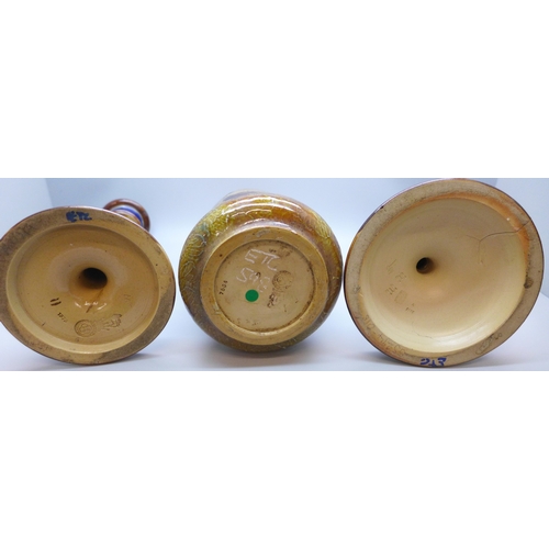 2004 - A Royal Doulton Autumn Leaves vase and candlestick, and a Doulton Lambeth Art Nouveau candlestick, v... 