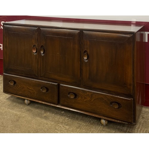84 - An Ercol Golden Dawn elm Windsor sideboard