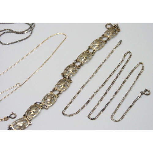 7058 - A 14ct gold chain, 1.2g, together with two 9ct gold hoop earrings, 0.6g, two silver chains, a bracel... 