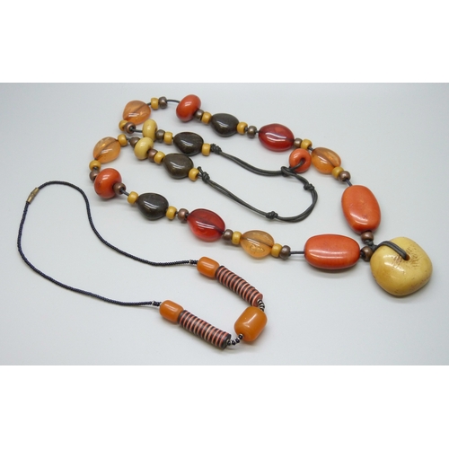 7124 - Two amber style necklaces, 116g total