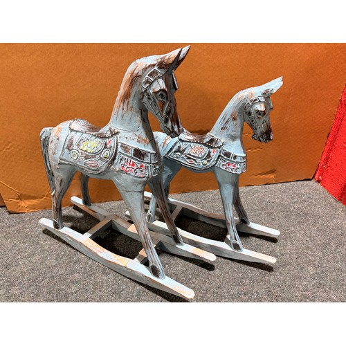3105 - A pair of blue painted rocking horse decorations