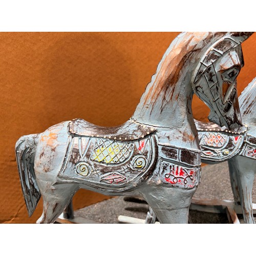 3105 - A pair of blue painted rocking horse decorations