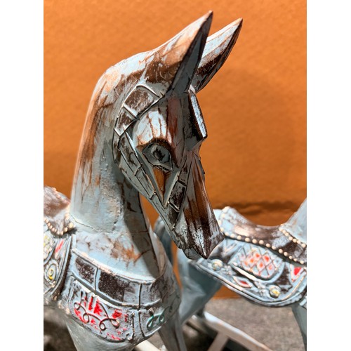3105 - A pair of blue painted rocking horse decorations