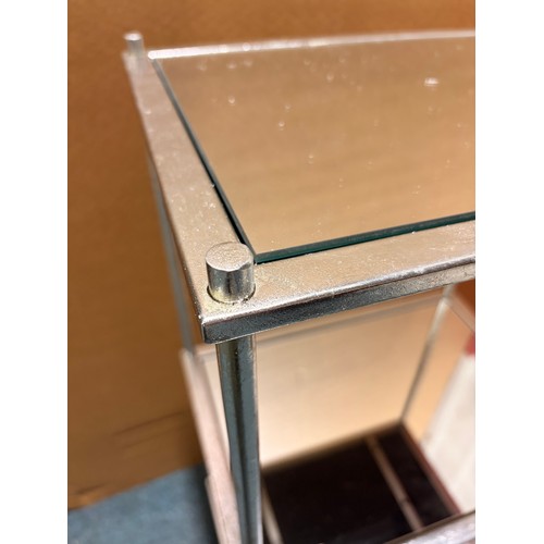 3110 - A silver effect mirrored three tier shelf unit (unchecked)