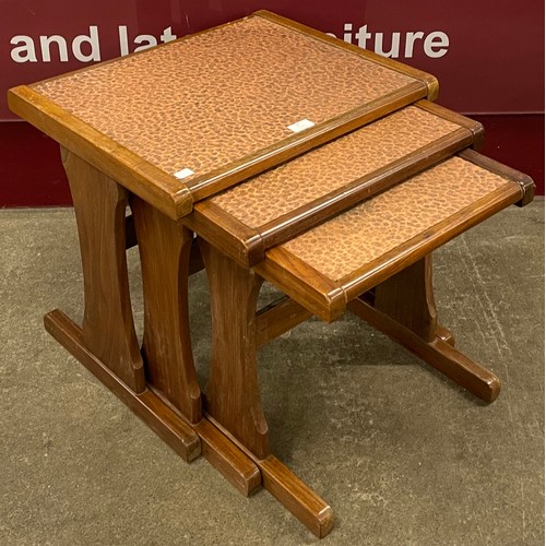 87 - A teak and copper topped nest of tables