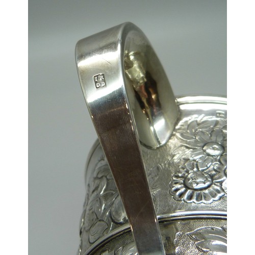 7001 - A George III silver two handled loving cup with embossed floral decoration, J Robertson & D Darling,... 