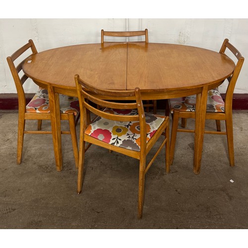 95 - A teak oval extending dining table and four chairs