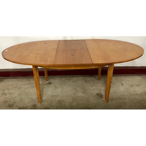 95 - A teak oval extending dining table and four chairs