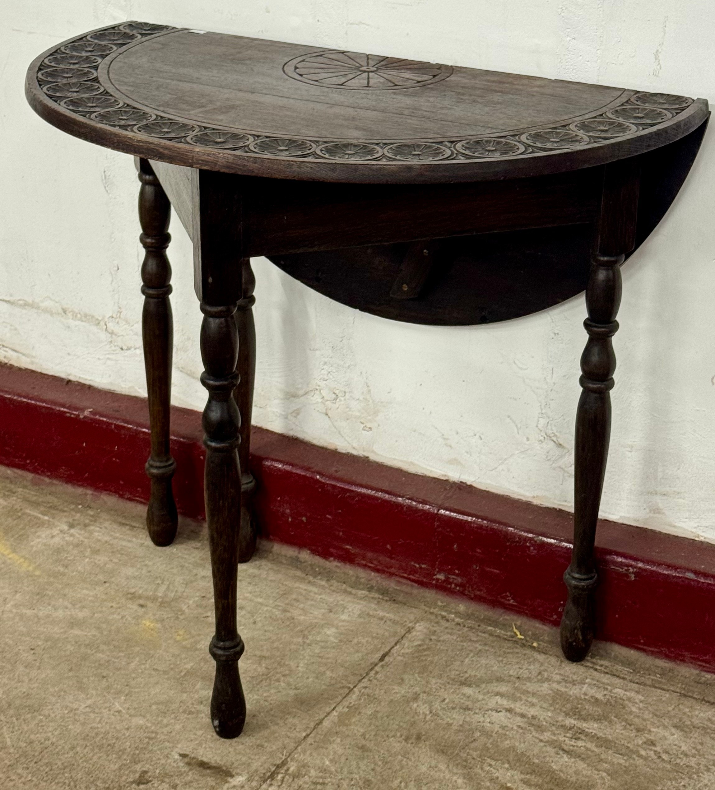An early 20th Century Jacobean Revival carved oak gateleg table