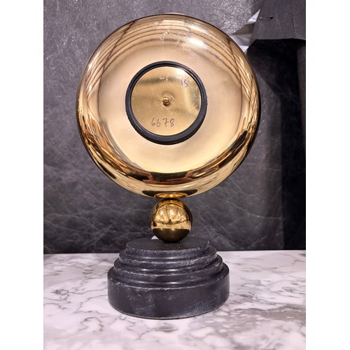 3026 - A Minster gold effect mantle clock on a circular black marble base