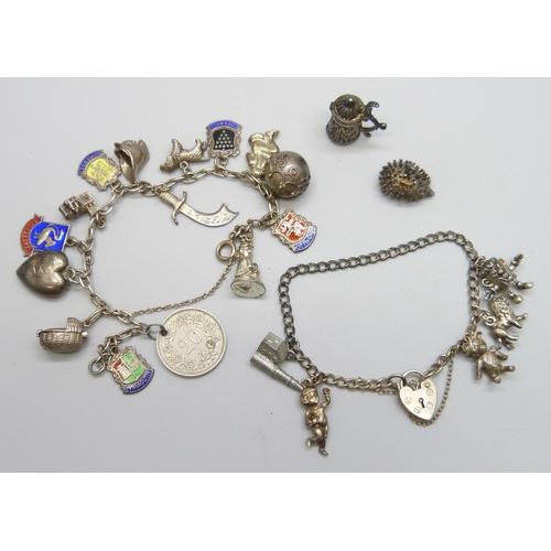 7071 - Two white metal charm bracelets with a collection of silver and white metal charms, on with a marked... 