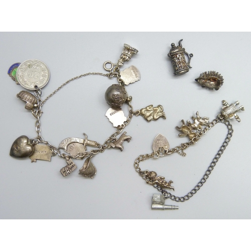 7071 - Two white metal charm bracelets with a collection of silver and white metal charms, on with a marked... 
