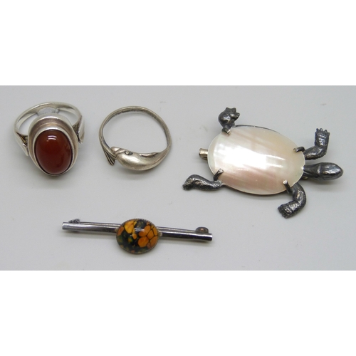 7081 - Two silver rings including carnelian, M.5, and one in the form of a dolphin, P, together with a silv... 