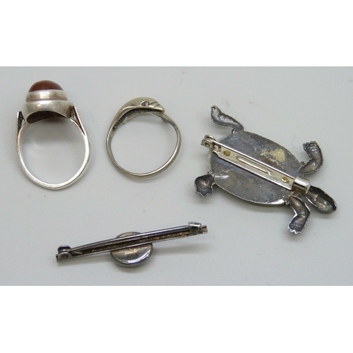7081 - Two silver rings including carnelian, M.5, and one in the form of a dolphin, P, together with a silv... 