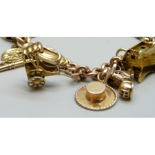 7092 - A 9ct gold curb chain charm bracelet with a collection of charms - ten 9ct gold charms, an 18ct gold... 