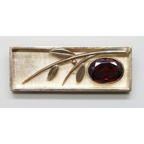 7097 - A Modernist .935 silver leaf design brooch set with a red stone (testing within the spinel region so... 